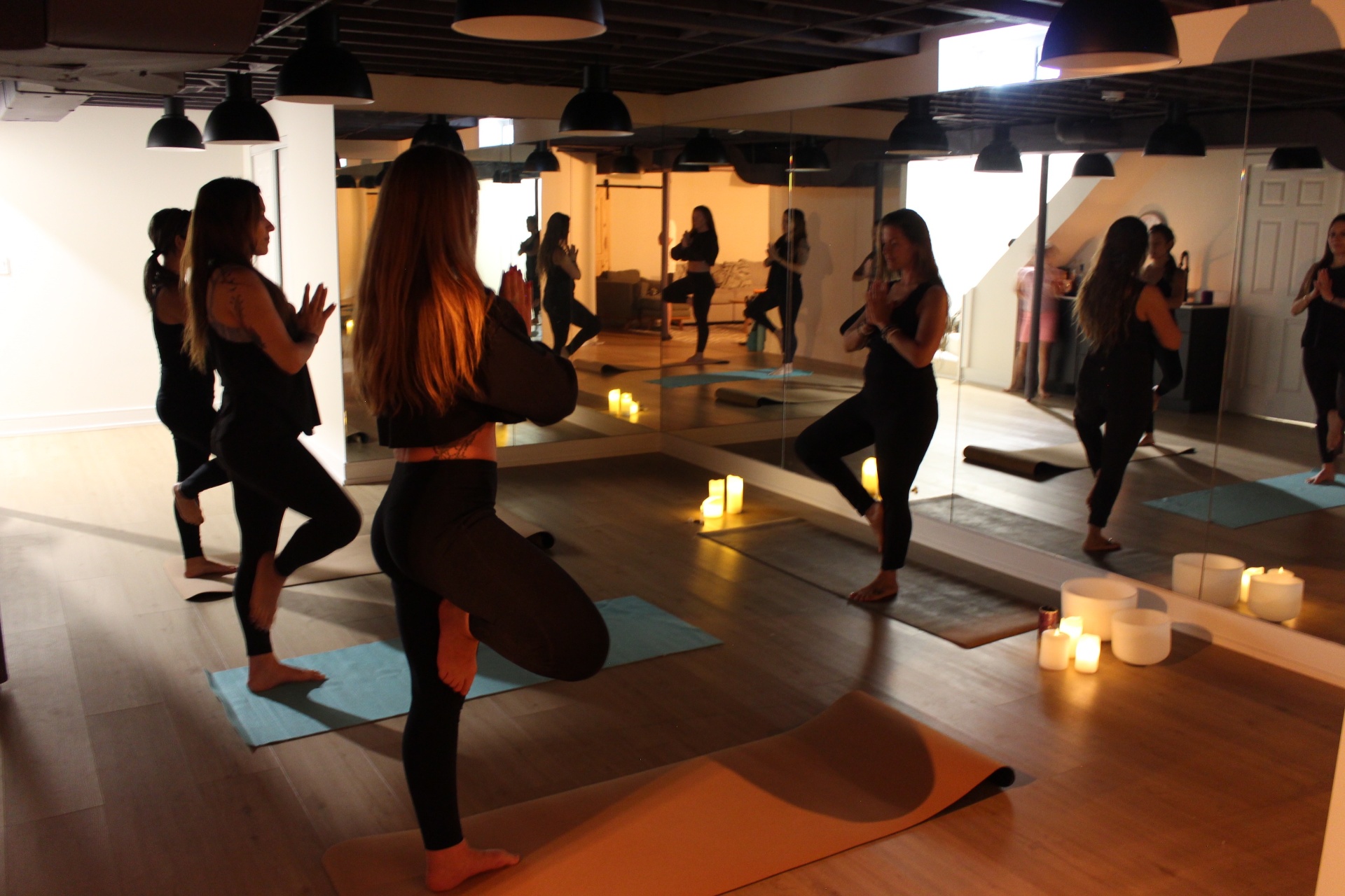 Group yoga session in a candlelit studio